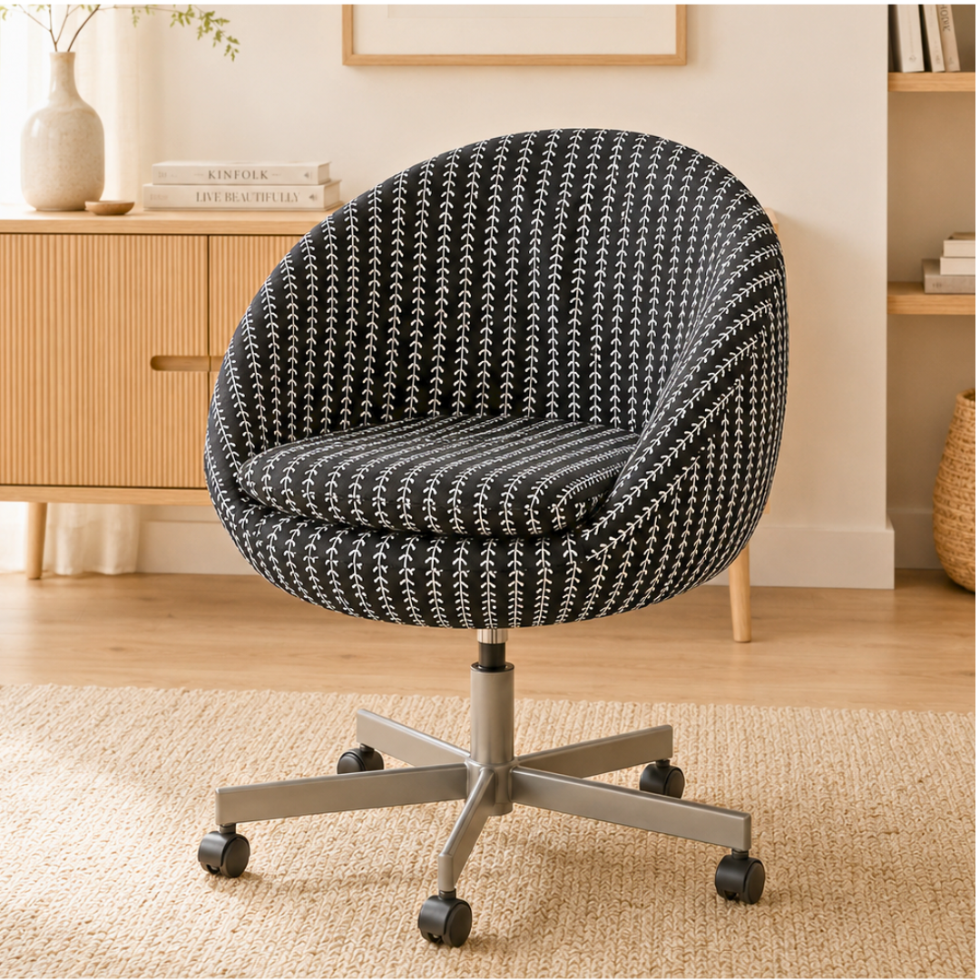 Patterned office chair in a home office setting with a wooden cabinet and books.
