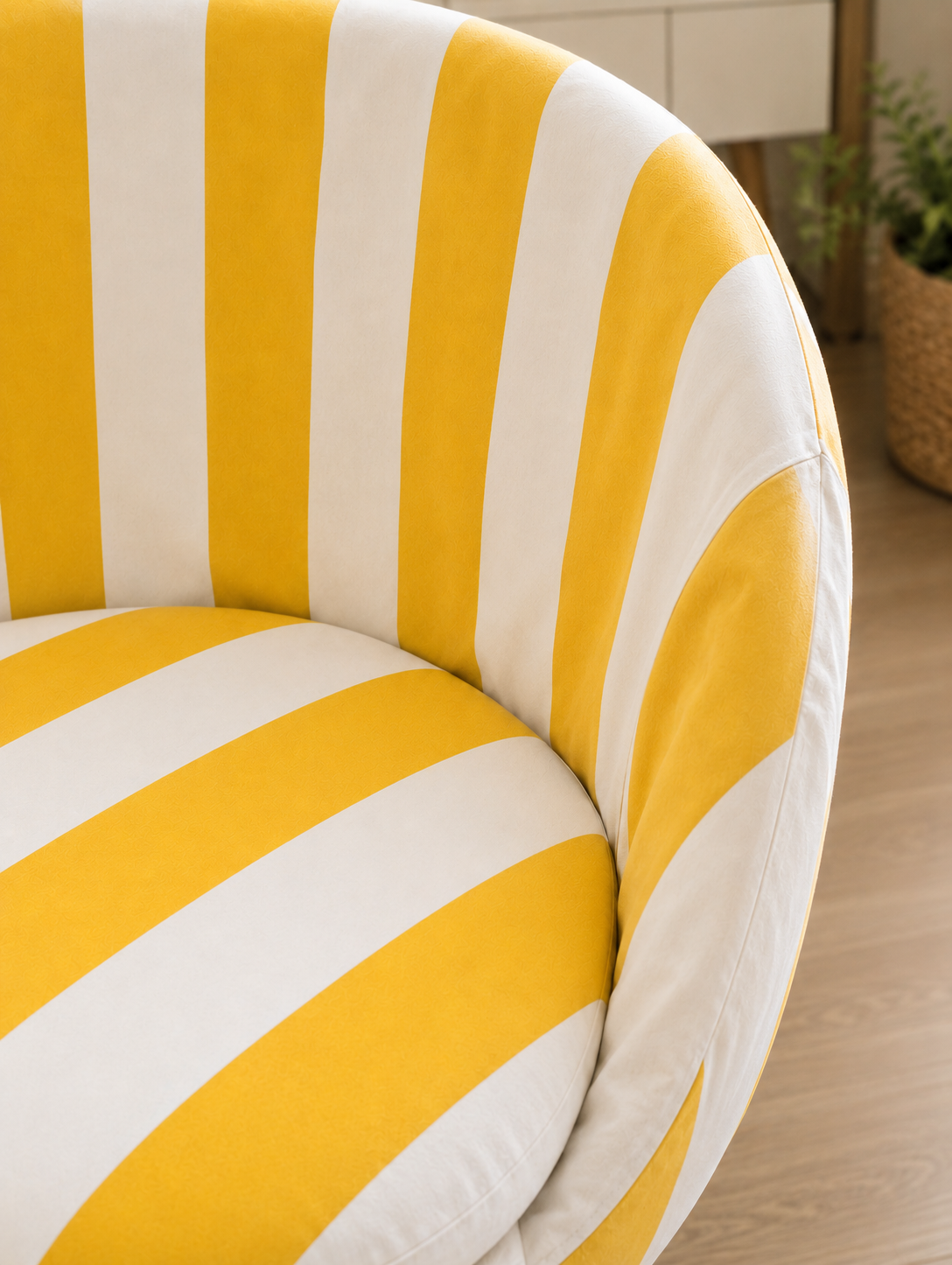 Chair with yellow and white striped pattern on a wooden floor.