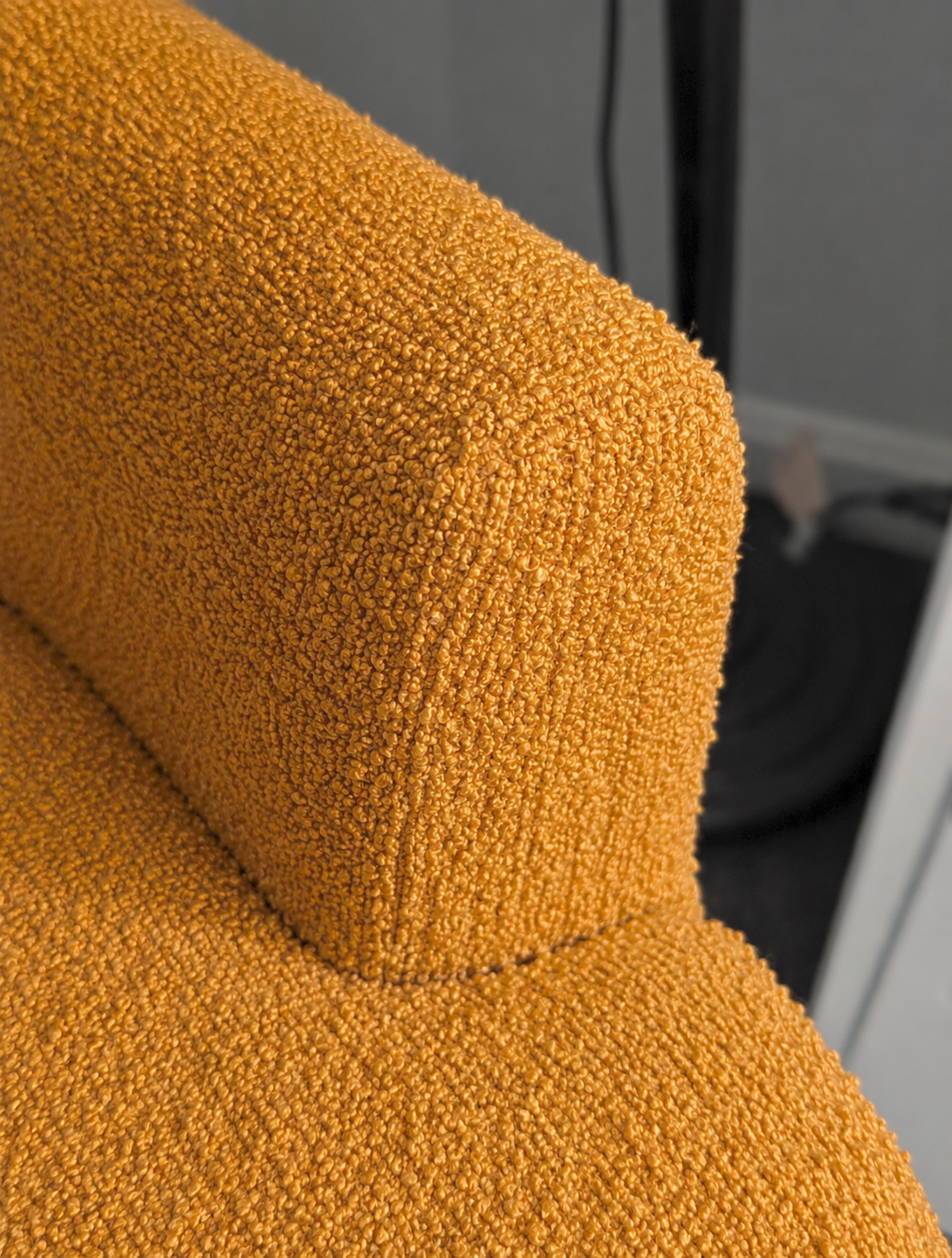 Close-up of a textured mustard yellow fabric surface.