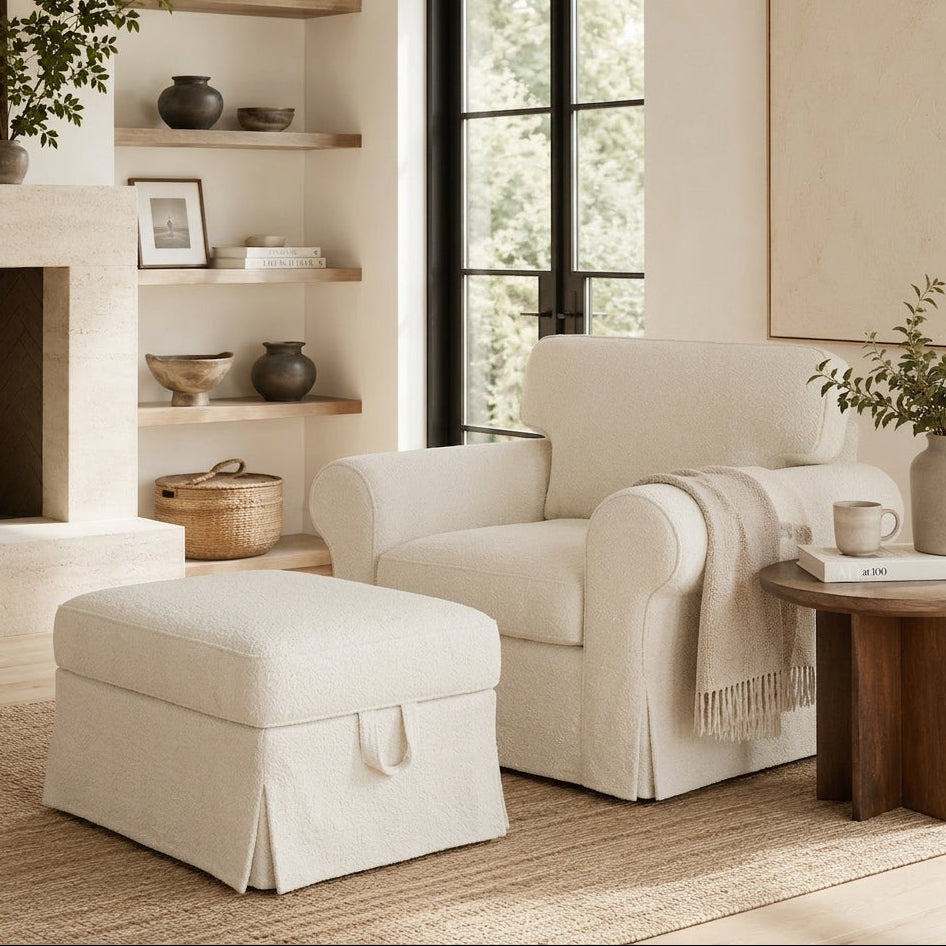 Cozy living room with white boucle armchair, ottoman, and wooden side table.