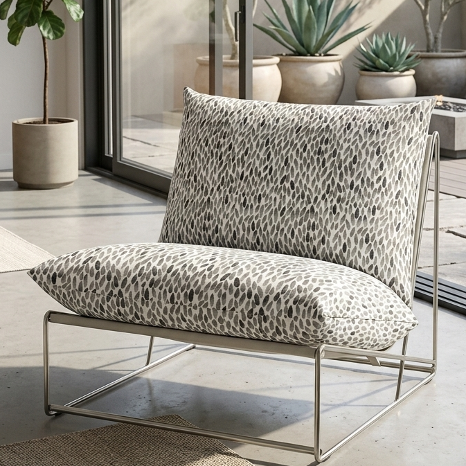 Modern outdoor chair with patterned cushions on a patio with plants and furniture.