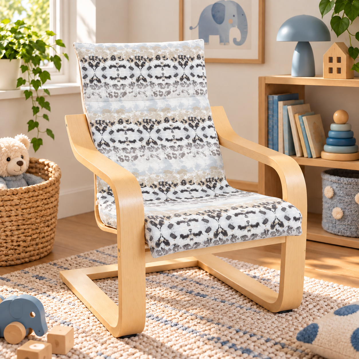 A kids IKEA Poang chair with a light beige frame and a patterned cushion in white, gray, and beige, set in a cozy, sunlit children's room.