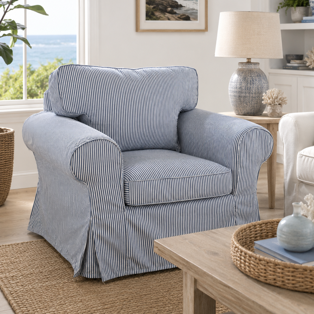 Blue striped armchair in a living room with a window view, lamp, and decor items.