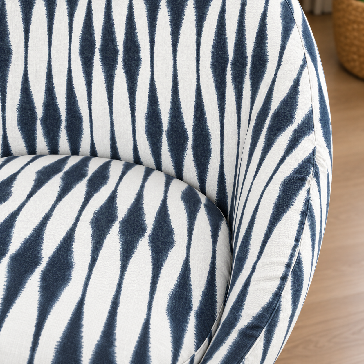 Close-up of a curved upholstered chair or sofa arm with a bold zebra-like pattern in dark navy blue and white, set against a light wood floor background.