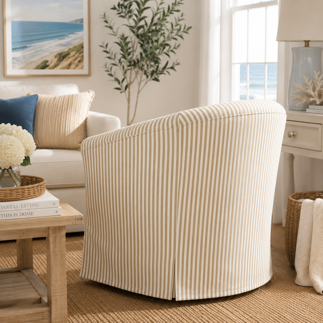 A striped fabric slipcovered barrel chair in a bright, modern living room setting.