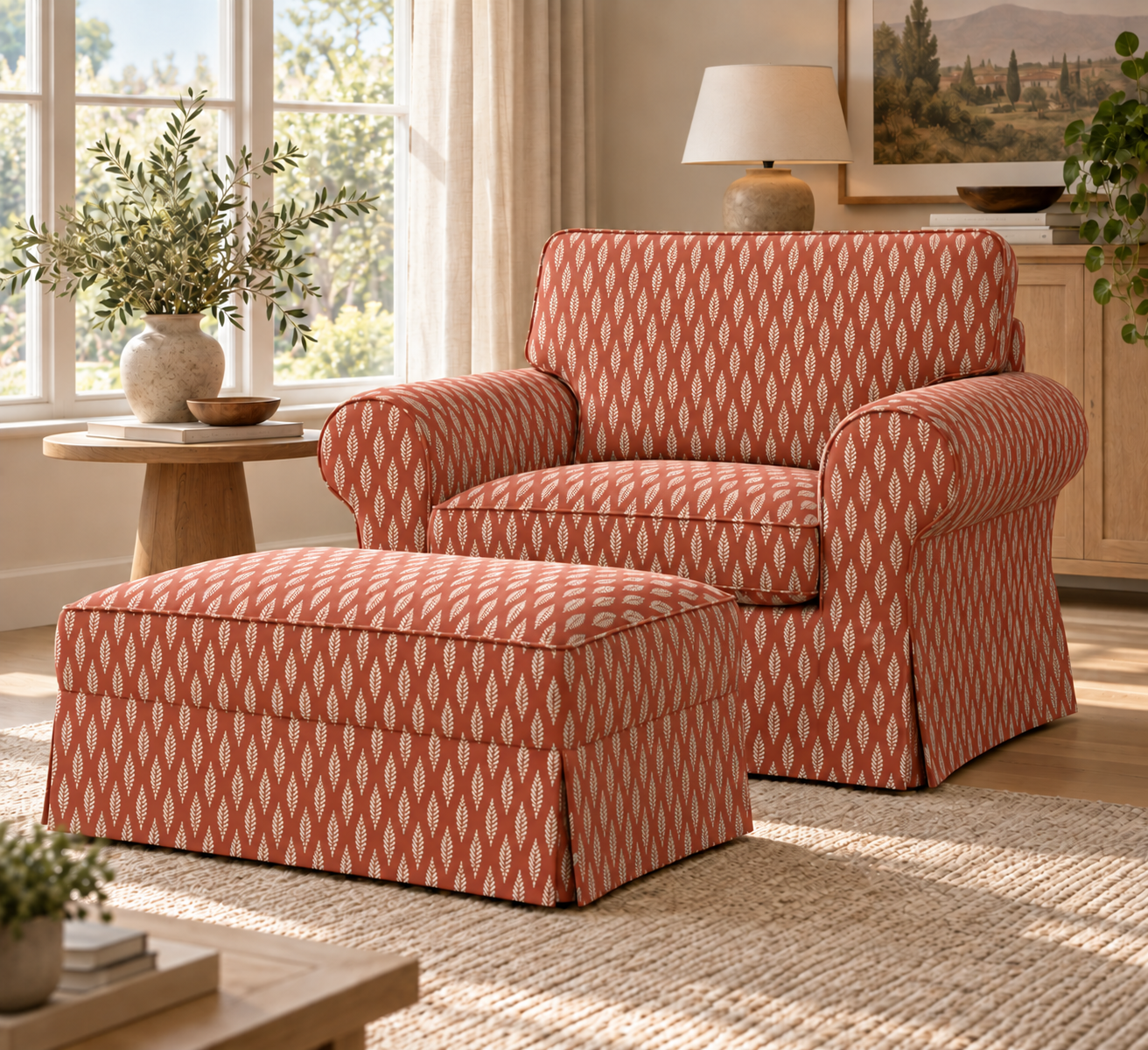 A matching armchair and ottoman set in a warm, sunlit living room. The furniture features a coral orange and cream geometric diamond pattern, with the ottoman positioned in front of the armchair.