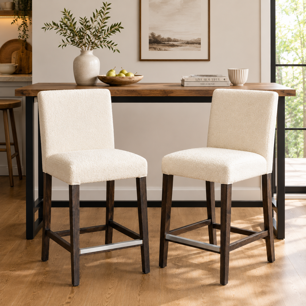 Two beige cushioned bar stools in front of a wooden dining table with decor items.
