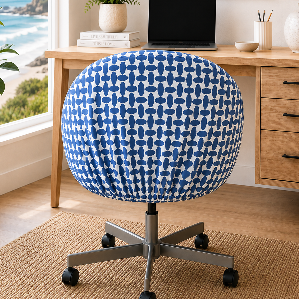 Blue patterned office chair in a home office with a desk and ocean view.