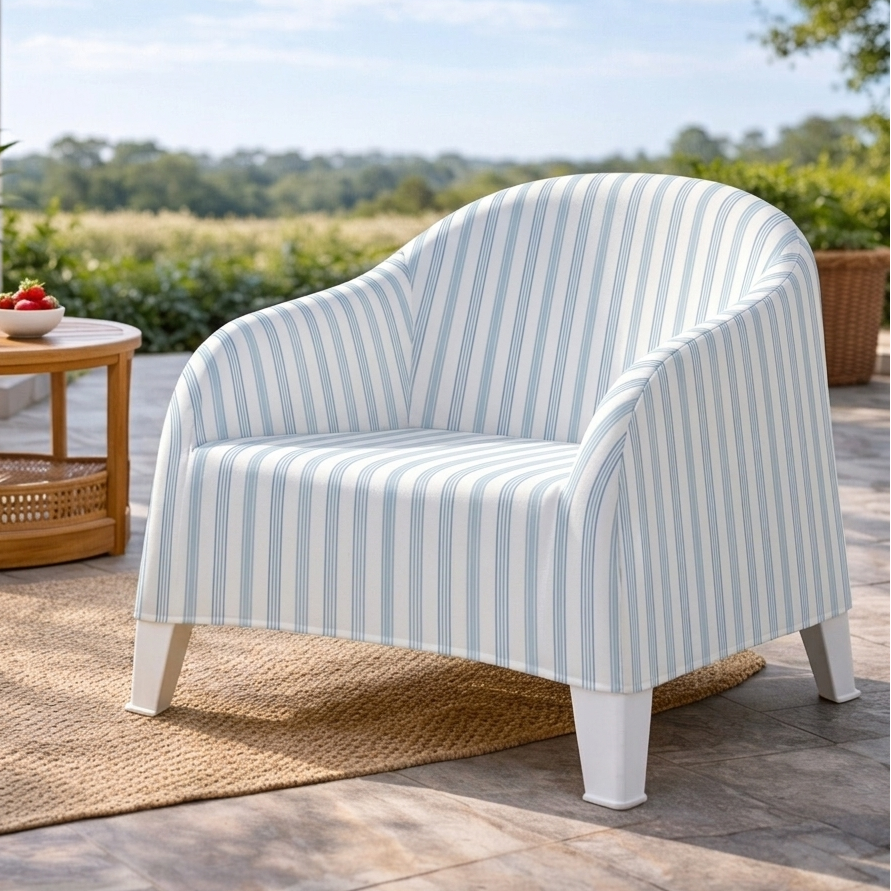 Striped outdoor chair on a patio with a view of a field and blue sky.