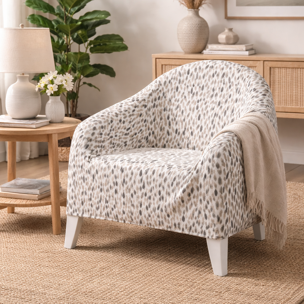 Patterned armchair in a living room with a plant and side table.