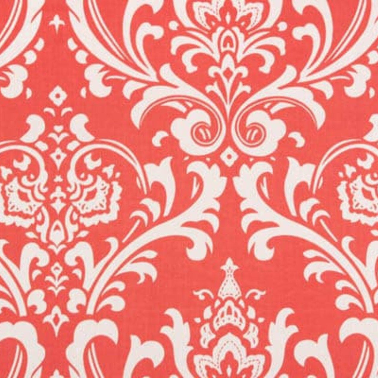 White floral damask pattern on a coral background