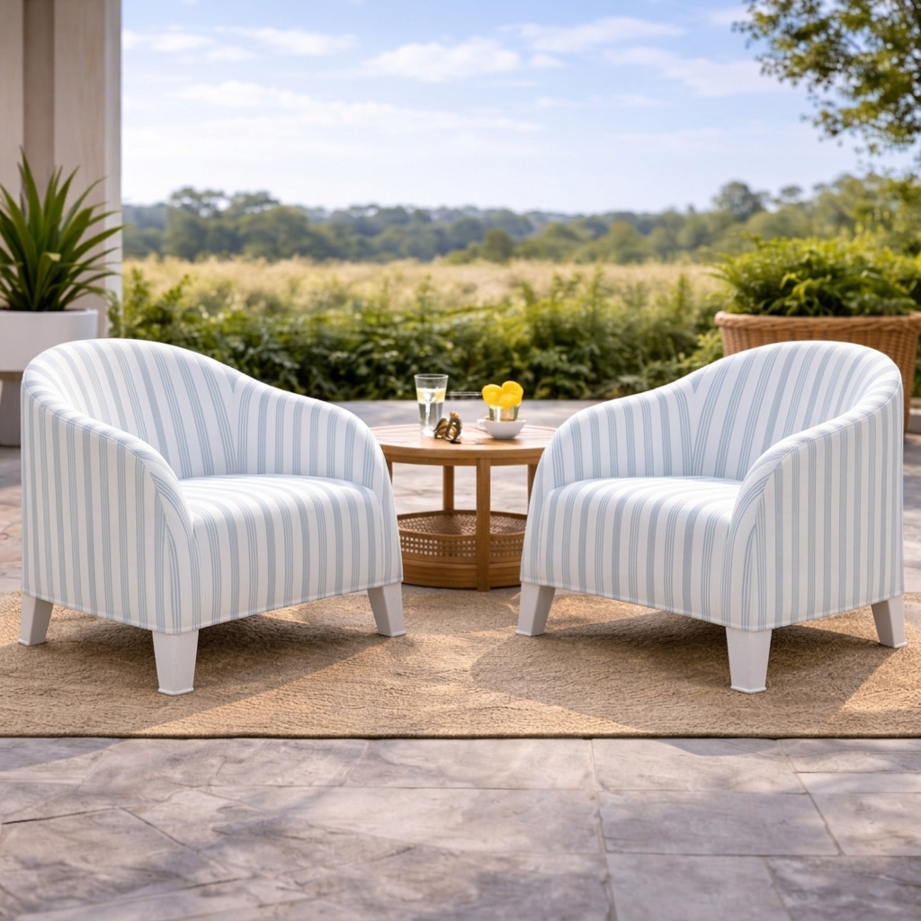Two striped armchairs on a patio with a scenic background
